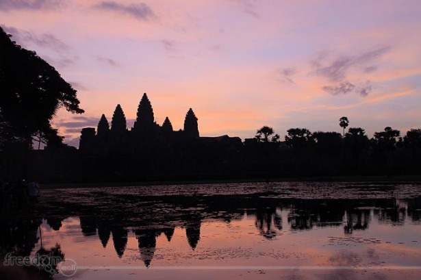 Angkor Wat Sunrise. The sky was covered with thin cloud so we did not witness the burst of colors - just shades of red