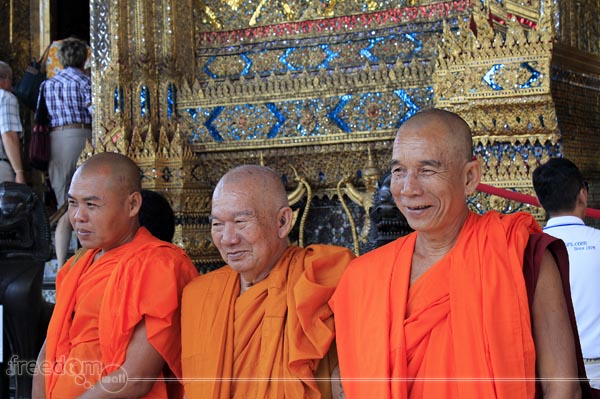 Monks posing for Tourists in the Monastery of the Emerald Buddha, Grand Palace