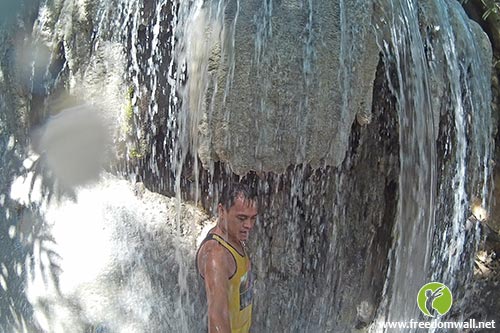 Getting a waterfall massage at Aguinid Falls no. 4