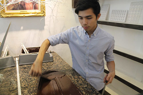 Jonathan, Ms Raquel's son, also conche and mold chocolates for guests