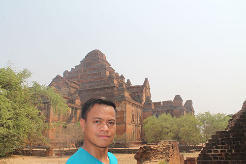 In the background is Dhammayangyi Temple, Bagan's largest