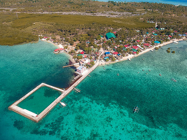 The rectangular structure is Barangay Ermita Pier, on its right is Basilia White Beach Resort, and on its left is Ermita's white strip.