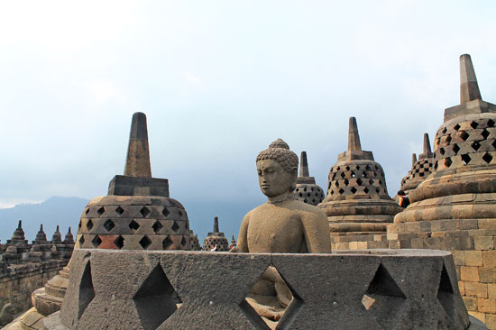 A Buddha statue inside a damaged Stupa in Borobudur