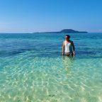 Ian Limpangog while wading the shallows of Mahaba Island with Himokilan Island in the background