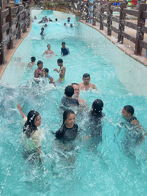 Trying to survive Campuestohan's wave pool while carrying my nephew